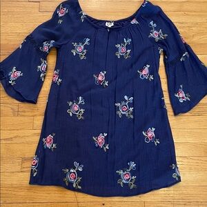 fig and flower navy blue garment with pink logo tag